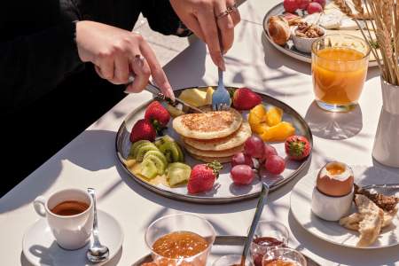 Breakfast with pancakes, egg and orange juice at Hôtel Athena Spa