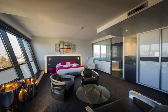 Room with double bed and large picture window at Hôtel Athena Spa in Strasbourg